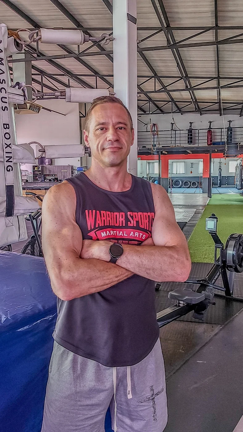 Coach Brett Clarke standing in his gym